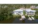 Waterfront homes with docks, boat lifts, and manicured lawns nestled among lush greenery at 216 High St, Tarpon Springs, FL 34689