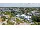 An aerial view shows the property and neighborhood surrounded by mature trees and water access at 216 High St, Tarpon Springs, FL 34689