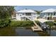 Waterfront home featuring boat dock, boat lift, and a charming home with a screened-in porch at 216 High St, Tarpon Springs, FL 34689