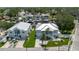 Aerial view showcasing two waterfront homes with boat docks and lush landscaping in a canal community at 216 High St, Tarpon Springs, FL 34689