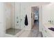 The bathroom features a glass door shower with built in shelves and marble throughout at 216 High St, Tarpon Springs, FL 34689
