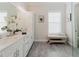 This bathroom features a double sink vanity with marble counters and tiled floors at 216 High St, Tarpon Springs, FL 34689
