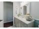 Well-lit bathroom featuring a white vanity with quartz countertop and decorative accents at 216 High St, Tarpon Springs, FL 34689