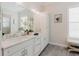 The bathroom features a double sink vanity with marble counters and natural lighting at 216 High St, Tarpon Springs, FL 34689