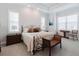 Spacious bedroom featuring a decorative bed frame, carpet, and natural lighting from large windows at 216 High St, Tarpon Springs, FL 34689