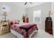 Cozy bedroom with colorful bedding, ceiling fan, and lots of natural lighting at 216 High St, Tarpon Springs, FL 34689