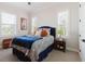 Cozy bedroom with blue accents, two windows, and a comfortable bed setup at 216 High St, Tarpon Springs, FL 34689