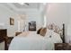 A bright bedroom featuring a decorative bed frame, carpet, and hard wood furniture at 216 High St, Tarpon Springs, FL 34689