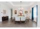 Dining room features a modern chandelier and a view of the exterior through the window at 216 High St, Tarpon Springs, FL 34689