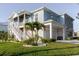 Detailed view of the home's exterior, showing the staircase, garage, well-maintained lawn, and coastal aesthetic at 216 High St, Tarpon Springs, FL 34689
