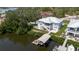 Waterfront home featuring a covered dock, boat lift and beautifully landscaped yard and mature trees at 216 High St, Tarpon Springs, FL 34689
