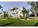 Charming two-story home with landscaped yard, white rock and a manicured lawn at 216 High St, Tarpon Springs, FL 34689
