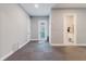 Neutral hallway leading to a bathroom and exterior entrance, providing ample space at 216 High St, Tarpon Springs, FL 34689