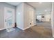 Hallway with access to the bathroom and game room, features neutral color scheme at 216 High St, Tarpon Springs, FL 34689