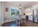 Breakfast nook with a table, barstools, and large windows offering natural light at 216 High St, Tarpon Springs, FL 34689