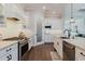 Beautiful kitchen with stainless appliances, granite counters, and views to the living area at 216 High St, Tarpon Springs, FL 34689