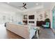 Bright living room with a decorative fireplace, modern fan, and an open layout for entertaining at 216 High St, Tarpon Springs, FL 34689