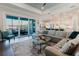 Bright living room with access to the screened outdoor patio, perfect for relaxing and entertaining at 216 High St, Tarpon Springs, FL 34689