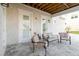 Cozy outdoor seating area with a tile floor, featuring outdoor sofa and chairs on covered patio at 216 High St, Tarpon Springs, FL 34689