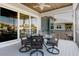 Screened in porch features outdoor dining set and panoramic views at 216 High St, Tarpon Springs, FL 34689