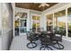 Covered porch with outdoor dining set and views of the neighborhood at 216 High St, Tarpon Springs, FL 34689