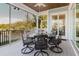 Screened porch with outdoor dining table and view of wooded backyard at 216 High St, Tarpon Springs, FL 34689