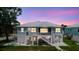 Lovely waterfront home featuring an upper porch and manicured lawn, perfect for outdoor living at 216 High St, Tarpon Springs, FL 34689