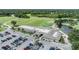 Aerial view of a club house and golf course features a parking lot and beautiful landscape at 2216 Eagle Bluff Dr, Valrico, FL 33596