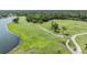 Golf course aerial view displays lush greens, walking paths, and tranquil water features on a sunny day at 2216 Eagle Bluff Dr, Valrico, FL 33596
