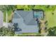 Aerial shot showcasing the home's roof, screened-in pool, landscaping, and proximity to lush greenery at 2216 Eagle Bluff Dr, Valrico, FL 33596