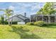 Lush green backyard view shows a section of the home with screened-in patio and green trees at 2216 Eagle Bluff Dr, Valrico, FL 33596