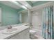 Classic bathroom with a teal accent wall, shower/tub combo, and ample mirror space at 2216 Eagle Bluff Dr, Valrico, FL 33596