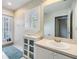 Bright bathroom with a modern vanity, plantation shutters, and view to the pool at 2216 Eagle Bluff Dr, Valrico, FL 33596