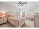 Charming bedroom with pink and white decor, featuring a ceiling fan and lots of light at 2216 Eagle Bluff Dr, Valrico, FL 33596
