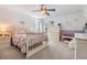 Bright bedroom with decorative purple and white walls, a ceiling fan, and carpet at 2216 Eagle Bluff Dr, Valrico, FL 33596