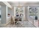 Bright breakfast nook with backyard views, a charming light fixture, and easy access to the lanai at 2216 Eagle Bluff Dr, Valrico, FL 33596