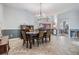 Elegant dining room with a chandelier, wainscoting, tile floors, and ample space for entertaining at 2216 Eagle Bluff Dr, Valrico, FL 33596