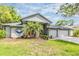 Charming home boasting a two-car garage, lush palm trees, and manicured landscaping for enhanced curb appeal at 2216 Eagle Bluff Dr, Valrico, FL 33596