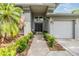 Inviting front porch featuring a double-door entrance, lush greenery, and an American flag accent at 2216 Eagle Bluff Dr, Valrico, FL 33596
