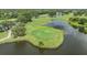 Aerial view of the meticulously maintained golf course, surrounded by serene water features and lush greenery at 2216 Eagle Bluff Dr, Valrico, FL 33596