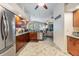 A kitchen featuring wooden cabinets, stainless steel appliances, and a view of the living area at 2216 Eagle Bluff Dr, Valrico, FL 33596