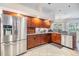 A kitchen featuring wooden cabinets, stainless steel appliances, granite counters, and ample natural light at 2216 Eagle Bluff Dr, Valrico, FL 33596
