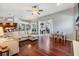 Open-concept living room with hardwood floors, a large sectional sofa, and access to the patio at 2216 Eagle Bluff Dr, Valrico, FL 33596