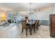 Open-concept living room with tile flooring, dining table and access to a screened lanai at 2216 Eagle Bluff Dr, Valrico, FL 33596