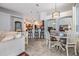 Open-concept living room featuring tile flooring, a breakfast bar, and a dining area with stylish lighting at 2216 Eagle Bluff Dr, Valrico, FL 33596