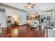 Spacious living room with hardwood floors, open layout, and seamless transition to the dining area and kitchen at 2216 Eagle Bluff Dr, Valrico, FL 33596