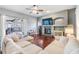 Cozy living room with a fireplace, hardwood floors, comfortable seating, and access to the patio at 2216 Eagle Bluff Dr, Valrico, FL 33596