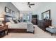 Large main bedroom featuring dark wood furniture, neutral tones, fan, and sliding glass door to outdoor patio at 2216 Eagle Bluff Dr, Valrico, FL 33596