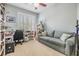 Comfortable home office with a blue sofa, desk, and lots of natural light at 2216 Eagle Bluff Dr, Valrico, FL 33596