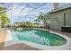 Relaxing screened-in pool and spa with a view of the lush green lawn and a clear blue sky at 2216 Eagle Bluff Dr, Valrico, FL 33596